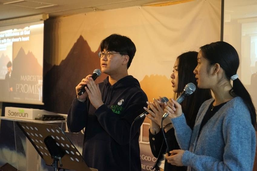 YEM students singing during Sunday worship
